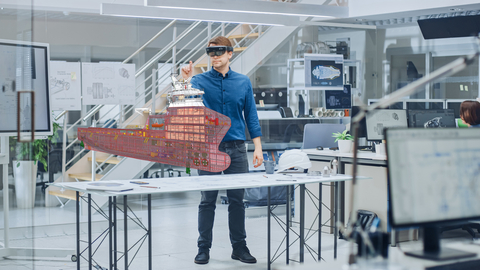 Engineering Software Developer Wearing Virtual Reality Headset Uses Gestures to Interact with Augmented Reality while Designing Industrial Engine Model in Modern Facility. AR Mock-up Concept